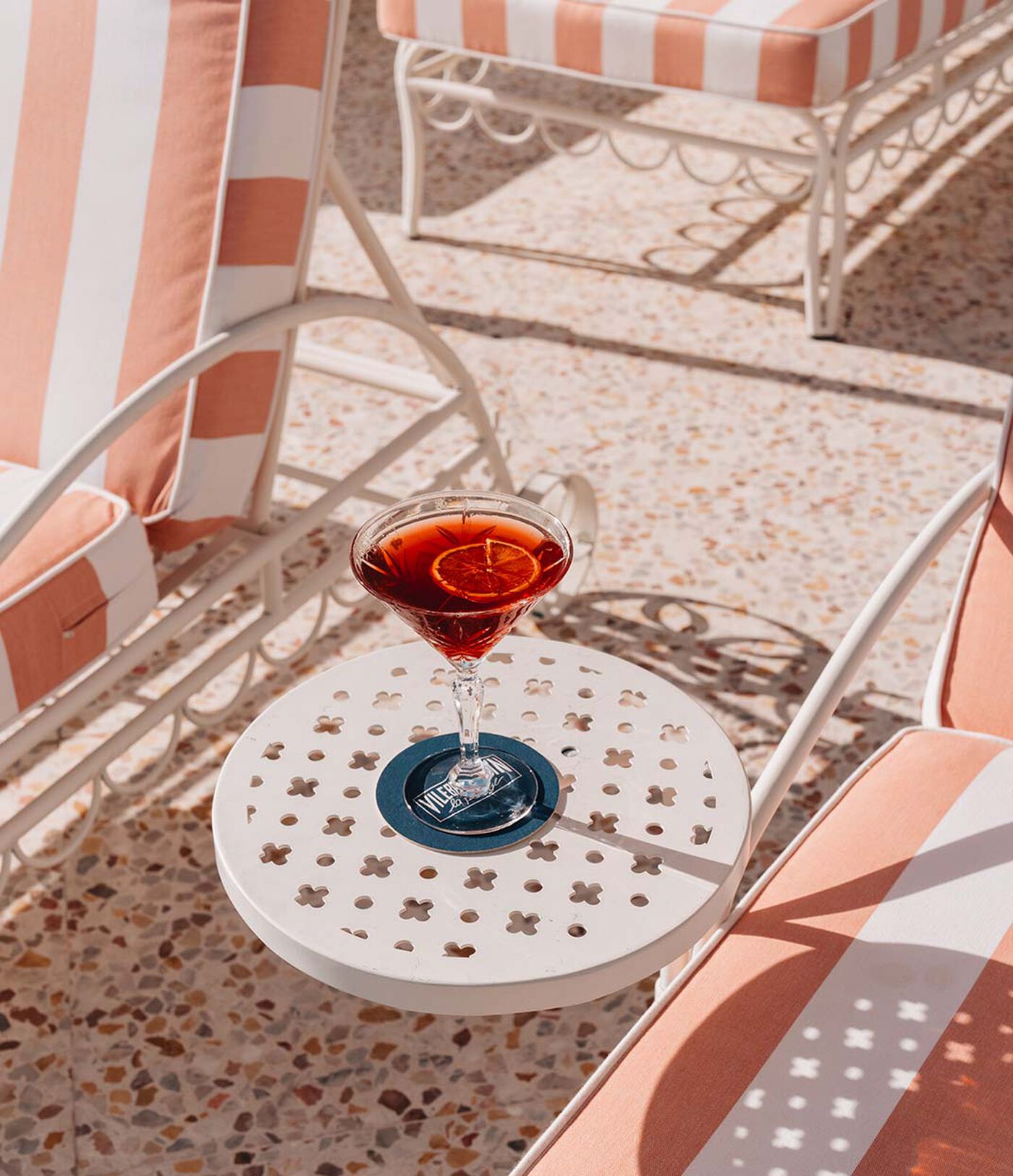 Cocktail on the striped Riviera-style terrace